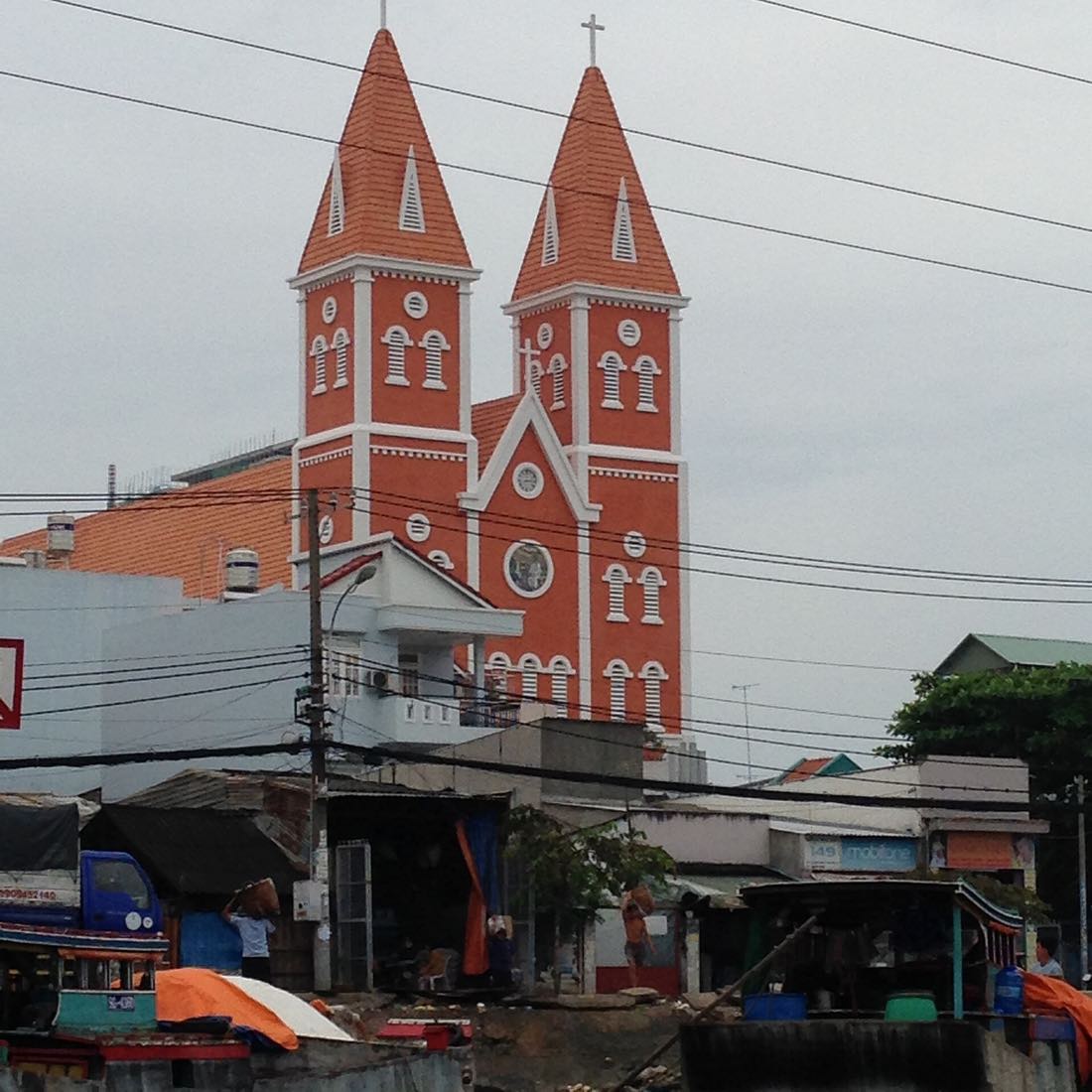 Hai Bà Trưng running north from the centre, the pink church, and Tân Định Market.